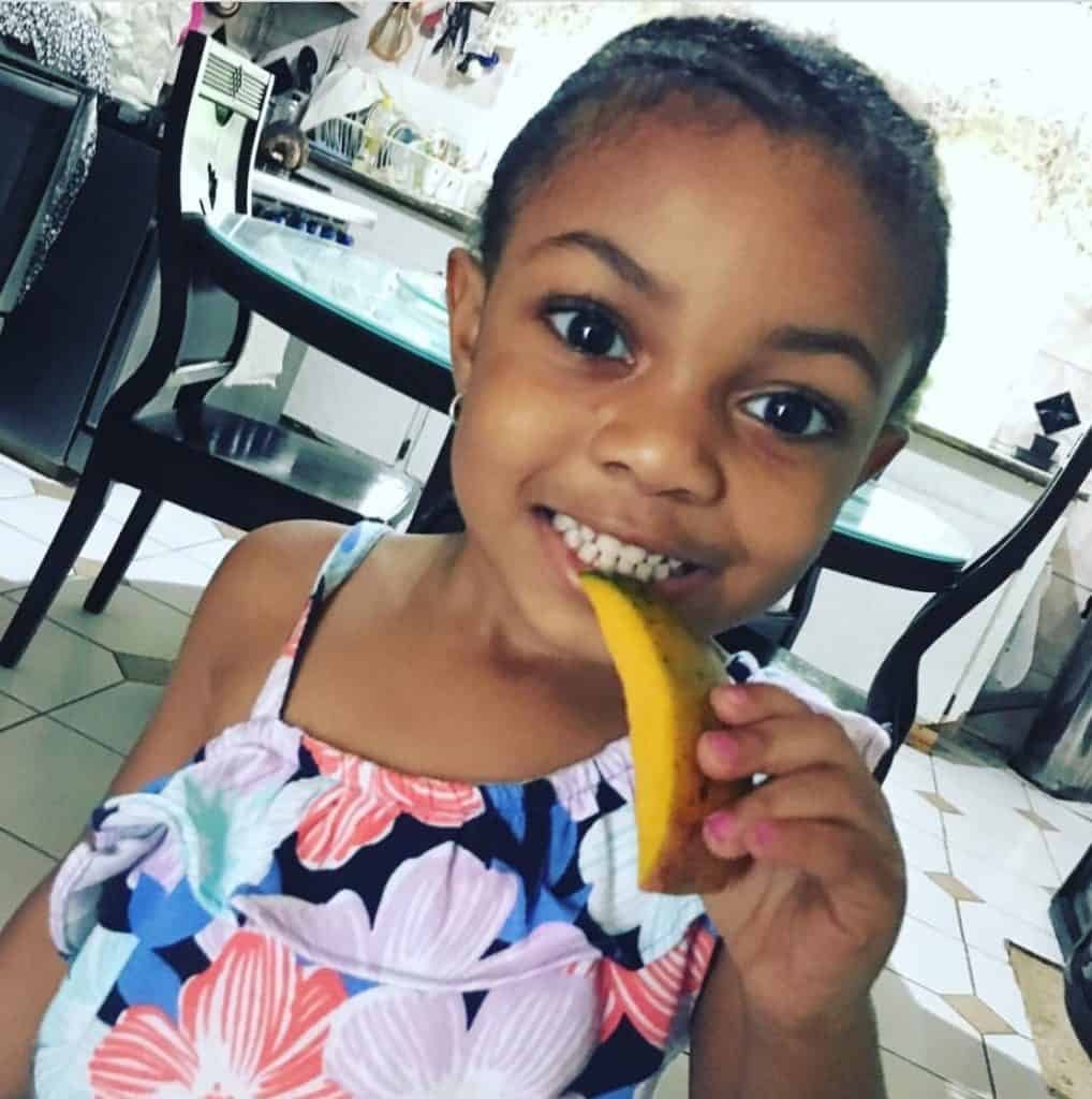 Anya enjoying Mango in Jamaica